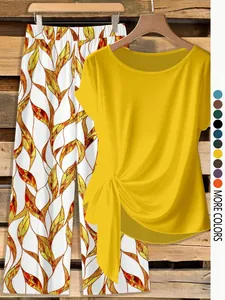 Detail view of yellow knot-front top and printed wide-leg trousers set
