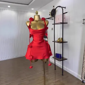 Detailed view of red sleeveless satin dress with 3D floral appliqués on a mannequin