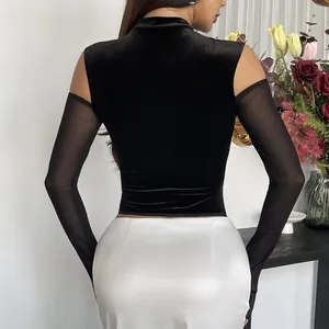 Back view of black velvet mock neck top with sheer mesh cold shoulder sleeves
