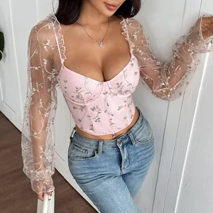 Detailed view of pink floral embroidered mesh corset top featuring long sheer sleeves