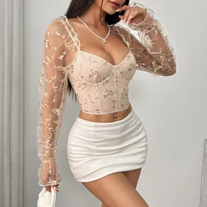Detailed view of embroidered mesh see-through corset top with floral long sleeves