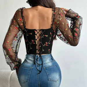 Detail shot of black floral embroidered mesh corset top with back lace-up closure