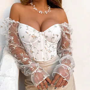 Detailed view of floral embroidered sheer mesh corset top with off-shoulder sleeves.