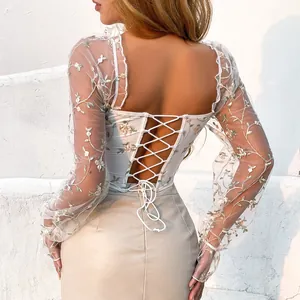 Detailed back view of white embroidered mesh long sleeve top with lace-up corset design