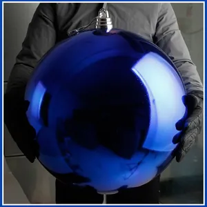 Nahaufnahme einer riesigen glänzenden blauen Weihnachtskugel, die die Größe zeigt