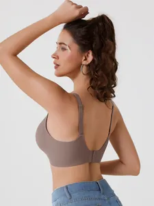 Detailed back view of a brown seamless non-wired bra on a female model with jeans.