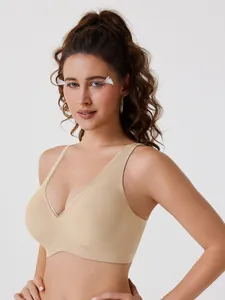 Detail showing smooth fit and seamless texture of a beige deep V wireless bra