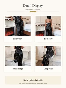 Detailed view of women's black satin celestial print camisole and pajama pants set