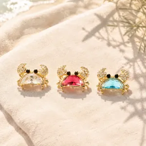 Detailed macro view of summer resort style crab brooches with blue and red crystals