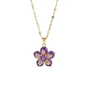 Elegant gold necklace with a rotating purple flower pendant and cubic zirconia