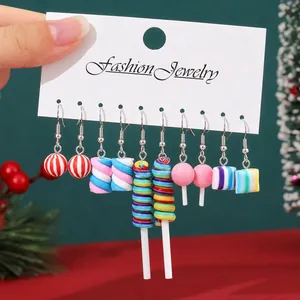 Macro view of various colorful candy-themed drop earrings set on a white display card.
