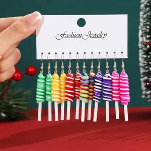 Detail view of colorful lollipop-shaped Christmas earrings set on a display card