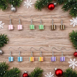 Detailed view of colorful striped candy drop earrings in a festive Christmas theme setting