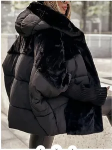 Stylish women's oversized black puffer jacket featuring luxury faux fur patchwork details