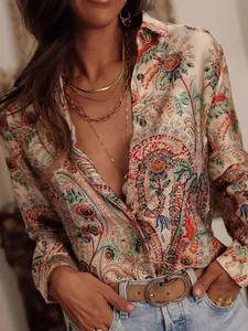 Close-up of vintage paisley and floral print long sleeve shirt with gold necklaces