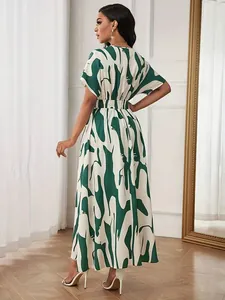 Back view of a stylish green abstract print maxi dress with cinched waist for women