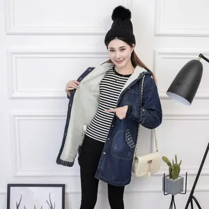 Detail of mid-length denim jacket showing thick white sherpa fleece lining inside
