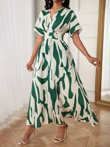 Elegant women's V-neck midi dress featuring vibrant green abstract print and cinched waist
