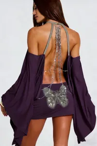 Detailed view of backless purple dress with silver chains and butterfly motif