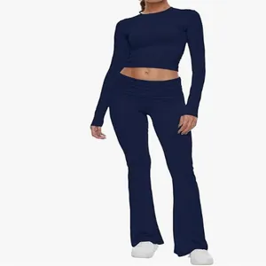 Close-up detail of navy blue two-piece yoga set with long sleeve crop top and flare pants