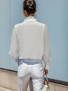 Back view of an elegant white long sleeve blouse featuring a ruffled collar detail