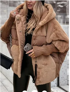Detail view of a women's camel oversized faux fur and quilted hooded puffer jacket.
