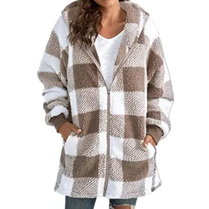 Close-up of an oversized brown and white plaid fleece hoodie with zipper and pockets