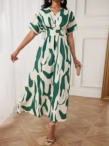 Elegant green abstract print maxi dress with v-neck and cinched waist design for women