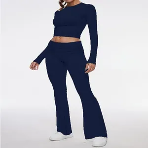 Elegant dark blue two-piece set featuring long sleeve crop top and flared yoga pants