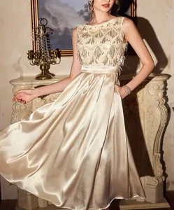 Exquisite detail of a champagne gold satin evening dress with shimmering sequin bodice