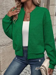 Close-up detail of a green textured bomber jacket featuring a geometric diamond pattern.