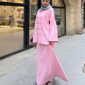 Elegant pink faux linen two-piece set with asymmetrical tunic and long flowing skirt
