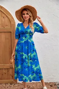 Full length view of elegant blue and green floral print maxi dress on a model