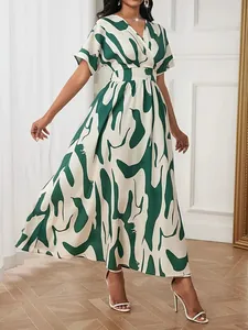 Elegant women's maxi dress with green and white abstract print, V-neck, and cinched waist