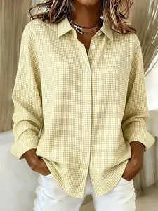 Front view of stylish women's yellow and white gingham long-sleeved shirt with lapels