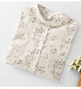 Folded off-white women's shirt featuring a vintage green leaf print and Peter Pan collar