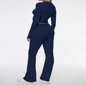 Back view detail of navy blue long-sleeve crop top and flare pants two-piece set.