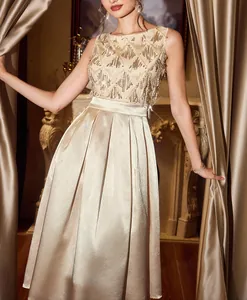 Detailed shot of a champagne satin maxi dress with a sequined bodice for evening parties