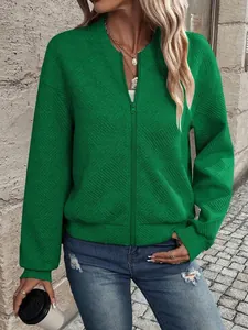Detailed view of women's green textured jacket with a zip-up front and baseball collar