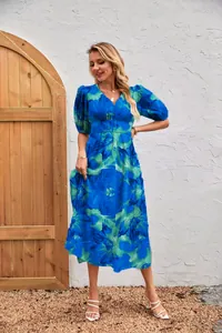 Close-up of blue floral print dress featuring V-neckline and puff sleeves design