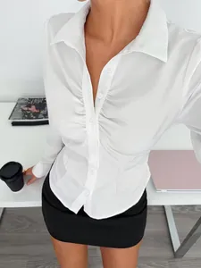 Detailed view of white long sleeve blouse with slim fit ruched waist and button down collar