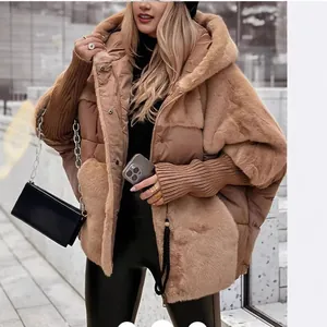 Stylish women's oversized patchwork puffer jacket with faux fur hood for winter