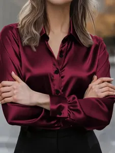 Close-up of elegant burgundy satin shirt showing shiny texture and button-down detail