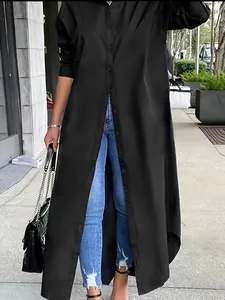 Oversized black long sleeve tunic shirt for women shown in a stylish street setting