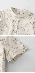 Detail view of a vintage floral print shirt featuring a Peter Pan collar and sleeves.