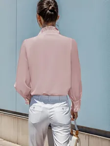 Back view of an elegant pink long sleeve blouse featuring a ruffled collar and silky texture