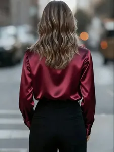 Back view of a maroon satin long-sleeved blouse showing glossy fabric and elegant fit