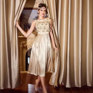 Elegant champagne satin evening gown with a sequined bodice and a midi pleated skirt