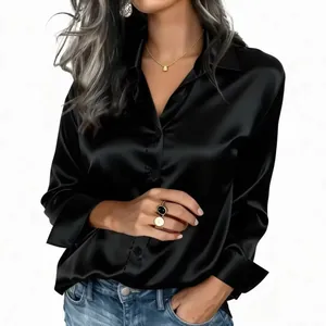 Close-up detail of an elegant black satin long-sleeved blouse with silk-like sheen finish.