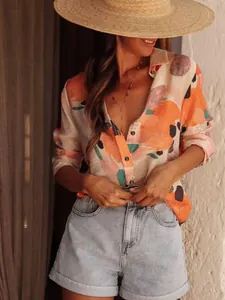 Close-up detail of women's elegant long sleeve printed shirt in relaxed vacation style
